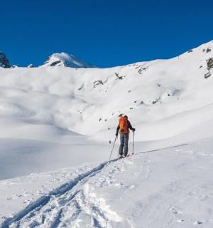 一个人在白雪皑皑的山上滑雪