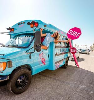 a dog is sticking its head out the window of an ice cream truck