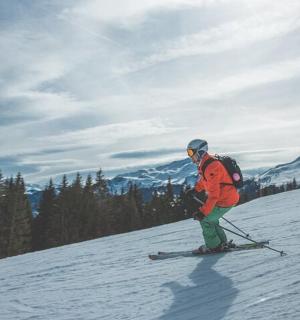 a man riding skis down a snow covered slope