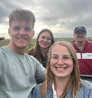 a group of people posing for a picture in a car