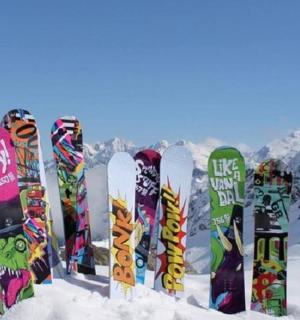 a row of snowboards are lined up in the snow