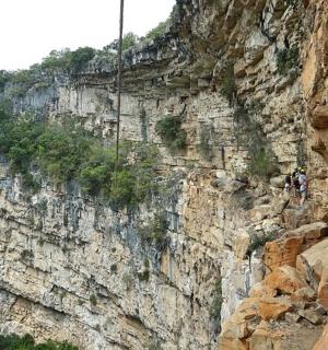 a person rappelling off of a mountain cliff