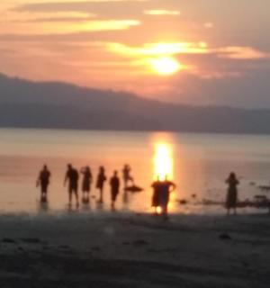 日落时分，一群人站在海滩上