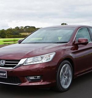 a red car is driving down a highway