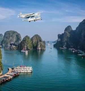 一架飞机正在飞越一条有船只的河流