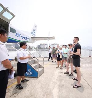 a group of people standing next to a bus