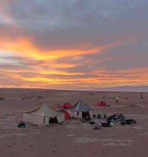 Skupina stanů v poušti při západu slunce