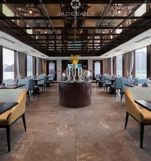 a restaurant with tables and chairs in a room with water