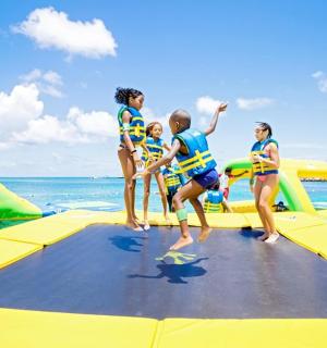 a group of children playing on an inflatable