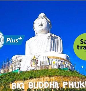 a large white statue sitting on top of a hill