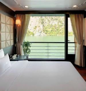 a bedroom with a large bed with a large window