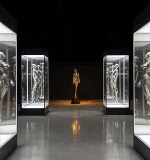 a display of mannequins in glass cases in a museum