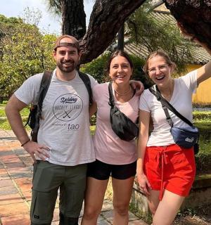 a group of three people posing for a picture