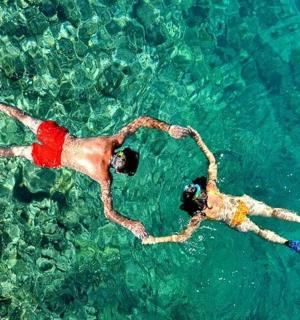 two people swimming in the water in the ocean