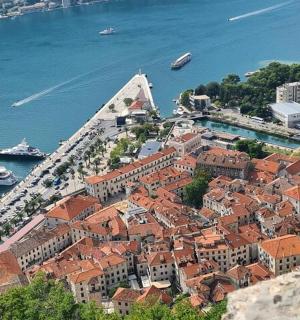 an aerial view of a city with boats in the water