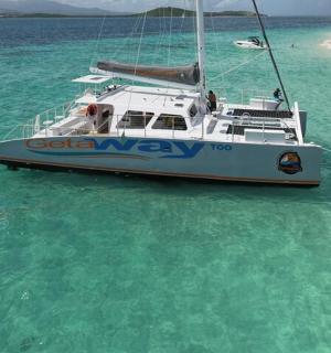 a boat in the water next to a beach