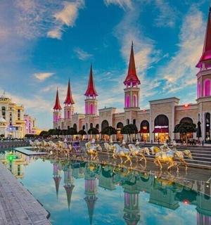 a view of the disney resort with its reflection in the water