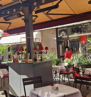 restaurace s bílými stoly a židlemi a slunečníkem