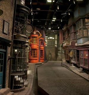 an empty alley in a building with red doors