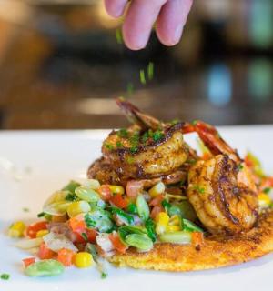 a plate of food with meat and vegetables on a table