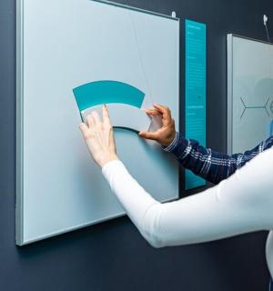 a woman is putting a book into a wall