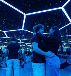 a group of people standing in a room with lights