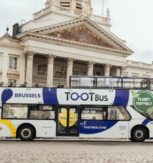 a double decker bus parked in front of a building