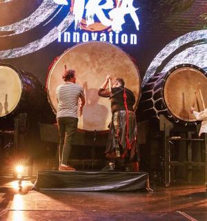a group of people standing on a stage with drums