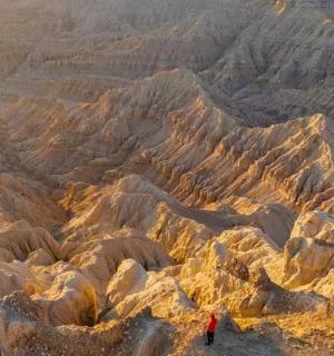 osoba stojící na vrcholu skalnaté hory