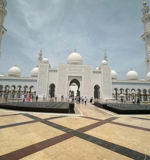 a large building with a mosque with two domes