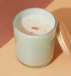 a small white cup with a spoon on a table