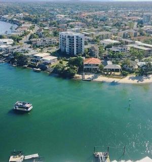 a boat in the water next to a beach