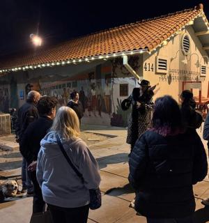 a group of people standing outside a building at night
