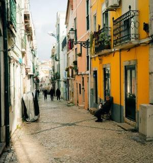an alley with people walking down a street