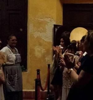 a group of people standing in front of a group of wine bottles
