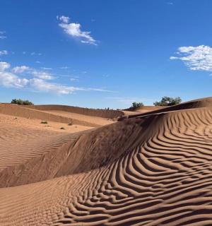 a sand dune in the middle of a desert