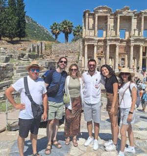 a group of people standing in front of the coliseum