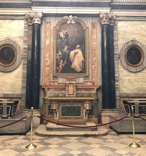 a room with a painting on the wall and a fireplace