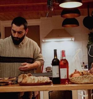 a man standing in a kitchen preparing food