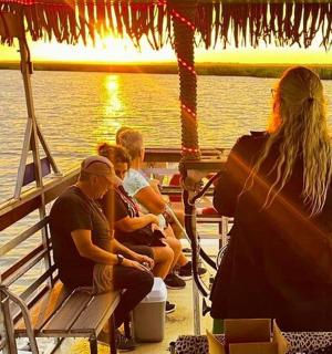 a group of people sitting on the deck of a boat