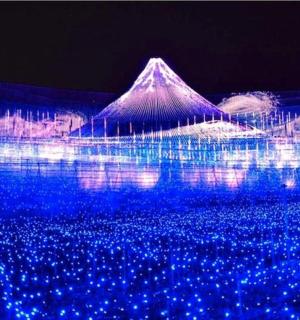 一座亮着灯的建筑，背景是一座山