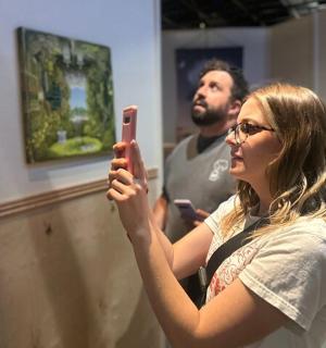 a woman taking a picture of herself in a mirror
