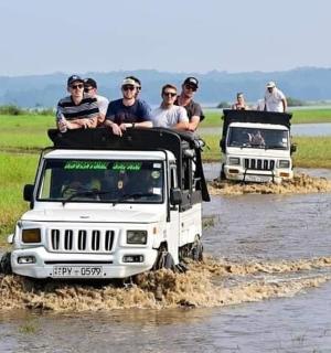 a group of people riding on the roof of a jeep