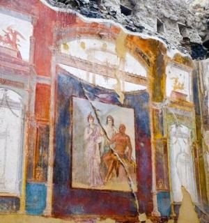 a room with paintings on the walls of a building