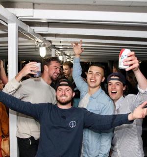 a group of people holding up their drinks