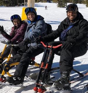 a group of people sitting on bikes in the snow