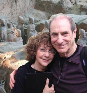 a man and a woman standing in front of a statue