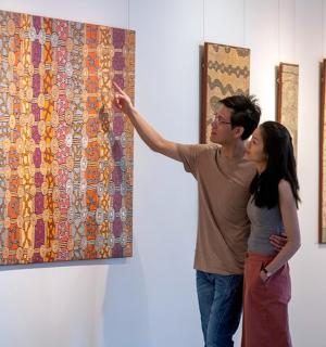 一男一女正在看墙上的一幅画