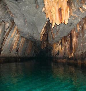 a cave with a pool of water in it