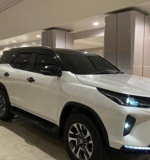 a white suv parked in a parking garage